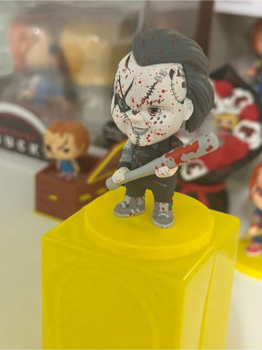 Funko Chucky Figure with Yellow Base and Red Splatter